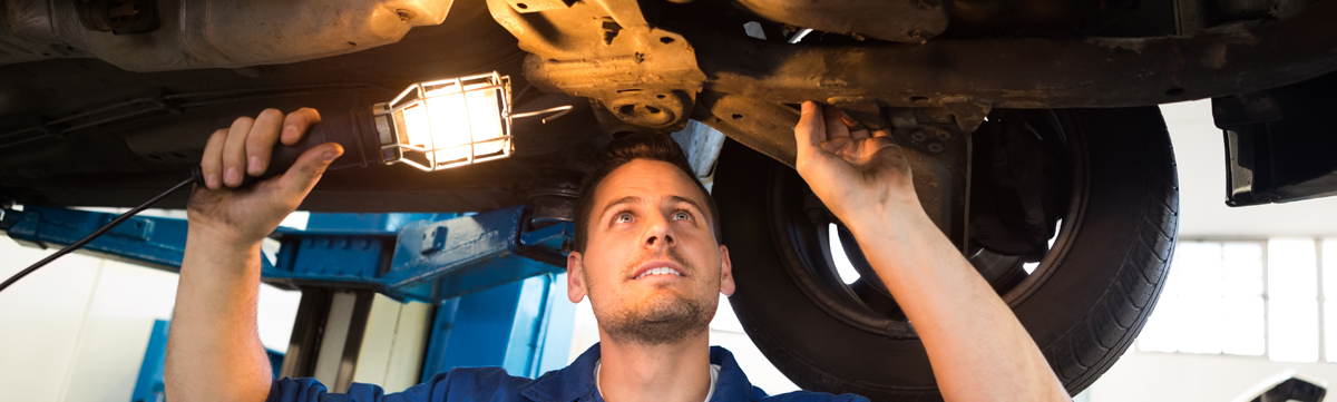 Mechanics doing an MOT test on a vehicle - MOT Derby