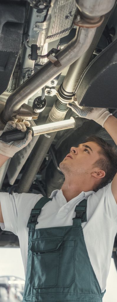 Mechanic working underneath a vehicle - MOT Testing Derby
